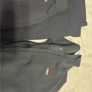 Figs Charcoal Pride jacket and straight leg scrub pants.